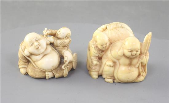 Two Japanese ivory netsuke of Hotei and a boy, Meiji period, width 4.1cm